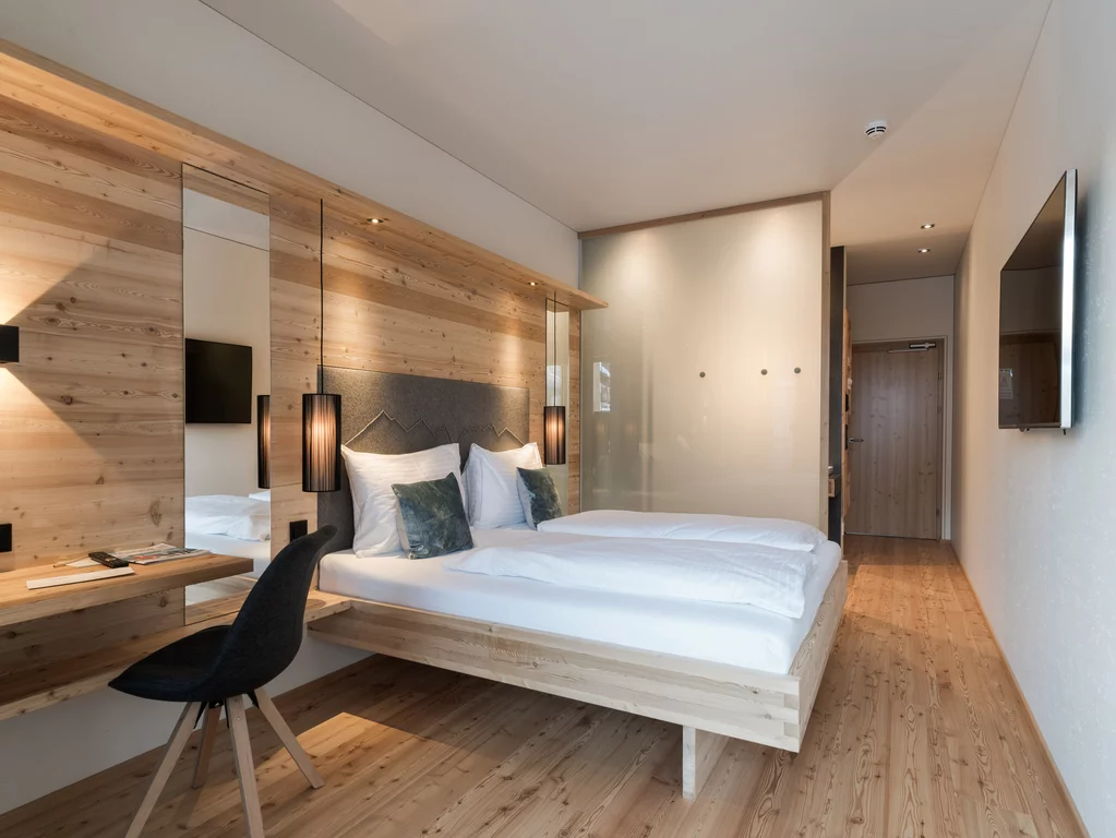 Bedroom in the Tirol Lodge, Austria. The bedrooms in the Tirol Lodge in Austria combine natural materials with modern, purist interiors.