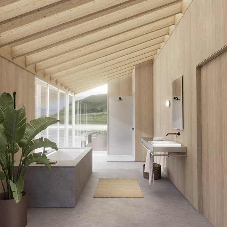 Lichte badkamer met bad, douche en wastafel in houtlook, met uitzicht op meer en bergen door grote raampartij.