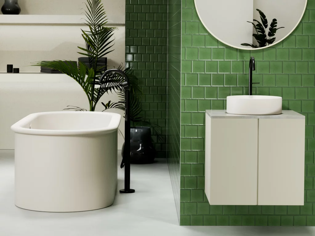 Baignoire en pose libre BetteSuno Oval et vasque à poser BetteSuno couleur flax avec robinetterie noire sur pied, dans une salle de bains moderne avec carrelage vert brillant, miroir mural intégré et plantes d'intérieur décoratives.