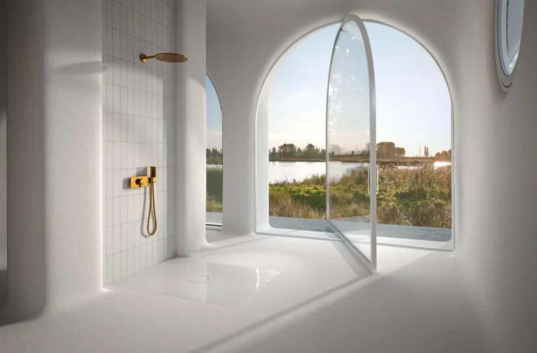 Rectangular steel enamel shower tray in bright, modern setting with large arches and view of nature.