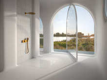 Rectangular steel enamel shower tray in bright, modern setting with large arches and view of nature.