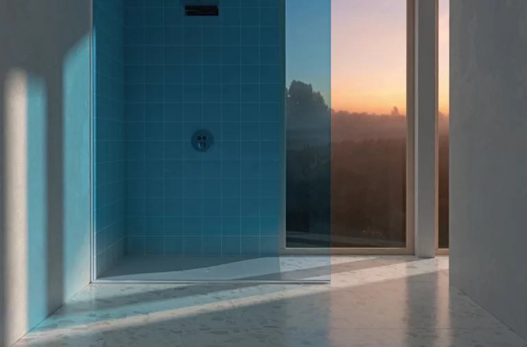 Rectangular steel enamel shower tray in modern glass shower with blue wall tiles.