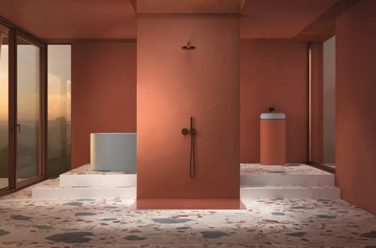 Freestanding round steel-enamel bathtub, central shower, washbasin on cylindrical countertop to the right, modern bathroom.