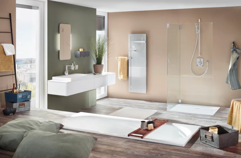 Large rectangular steel enamel bathtub, rectangular steel enamel shower tray, rectangular washbasin on countertop in modern bathroom.