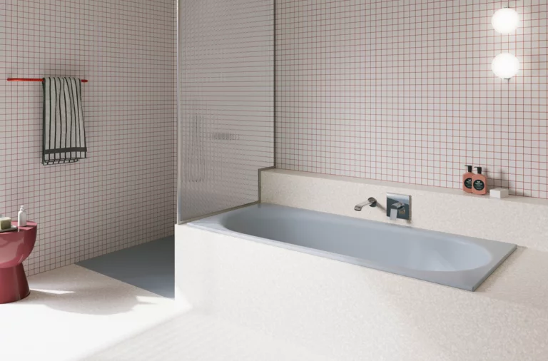 Light blue glazed titanium-steel bathtub in a bright bathroom with white tiles, wall faucet and open shower.