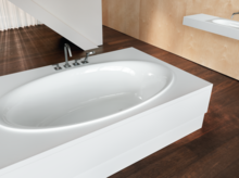 Oval steel-enamel bathtub integrated into white surround