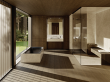 Современная ванная с чёрной встроенной ванной, душевым поддоном и стеклянной перегородкой, с видом на зелень.