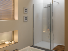 Rechteckige Badewanne und Duschfläche aus Stahl-Email in modernem Bad mit Glasduschwand und Ablage.