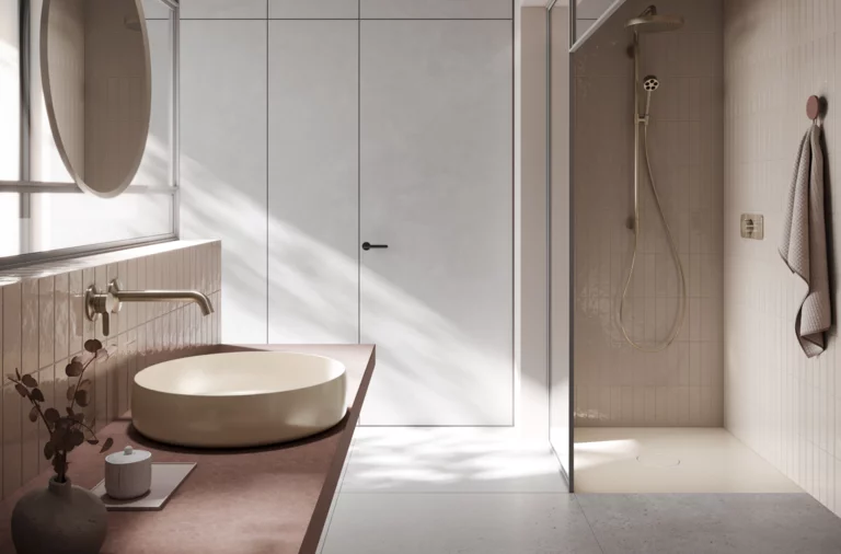 Wastafel op inbouwblad, rond, daarnaast vlakke, rechthoekige douchebak van staal-email in moderne badkamer.