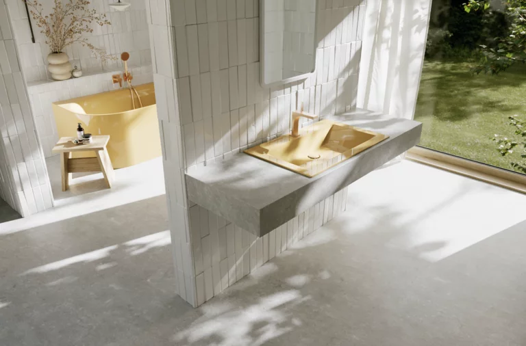Bright bathroom with a yellow washbasin and faucet in front of a large window overlooking the green garden.