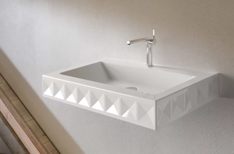 Rectangular steel enamel washbasin with geometric front, on countertop, wall-mounted, single faucet, modern look.