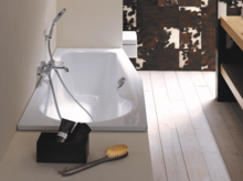 Vasca da bagno rettangolare in acciaio smaltato con rubinetteria, incassata in una superficie chiara, bagno moderno.