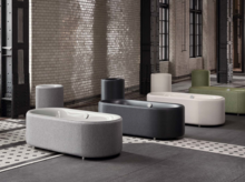 多款独立椭圆形钢瓷浴缸，外观多色，置于工业风室内。