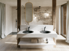 Bright bathroom with two dark grey washbasins, black wall-mounted taps, a large mirror and floor-to-ceiling windows.