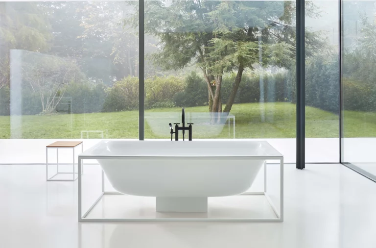 Freestanding rectangular bathtub and rectangular washbasin made of steel enamel on mounting plate, modern bathroom.