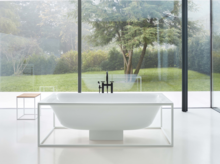 Freestanding rectangular bathtub and rectangular washbasin made of steel enamel on mounting plate, modern bathroom.