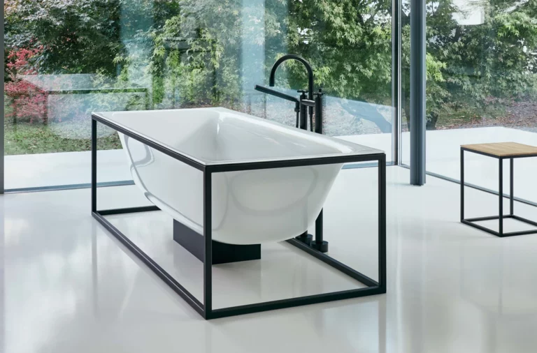 Steel enamel washbasin on rectangular countertop, freestanding rectangular steel enamel bathtub, minimalist bathroom.