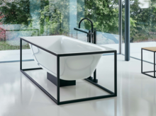 Steel enamel washbasin on rectangular countertop, freestanding rectangular steel enamel bathtub, minimalist bathroom.