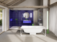 Modern bathroom with freestanding tub, violet-tiled shower and sink area, and green fittings in a rustic space.