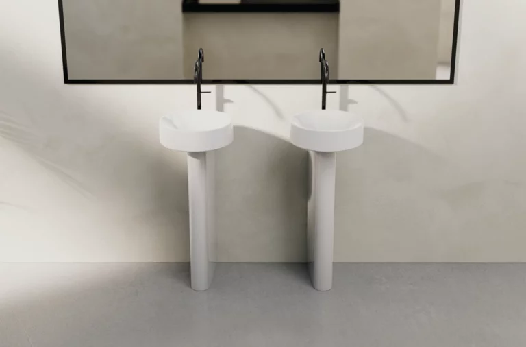 两个圆形搪瓷钢洗手盆，高底座，并排放在大墙镜前。