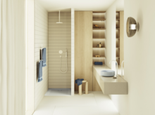 Bright bathroom with open shower, wall-mounted console with light blue countertop basin, and wood-look shelves.