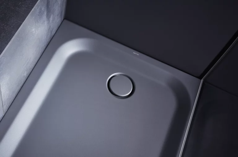 Square steel enamel shower tray with rounded corners and central drain, in a modern bathroom design.