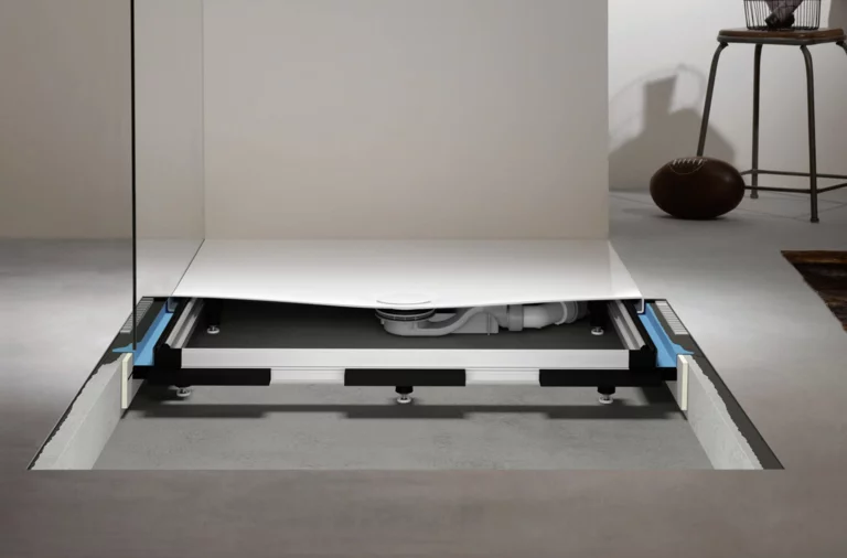 Universal installation system with shower tray, adjustable feet, and integrated drain in a modern bathroom.