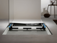 Universal installation system with shower tray, adjustable feet, and integrated drain in a modern bathroom.