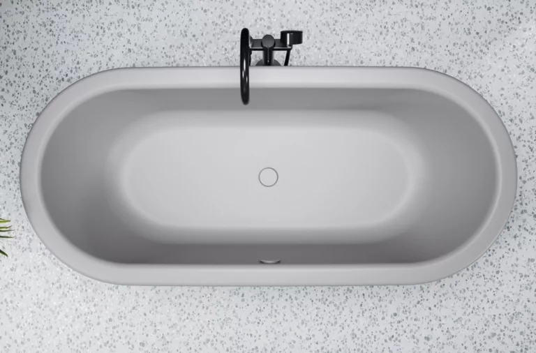 Oval bathtub made of steel enamel, freestanding, with centrally positioned drain, on light patterned floor.