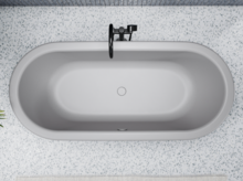 Oval bathtub made of steel enamel, freestanding, with centrally positioned drain, on light patterned floor.