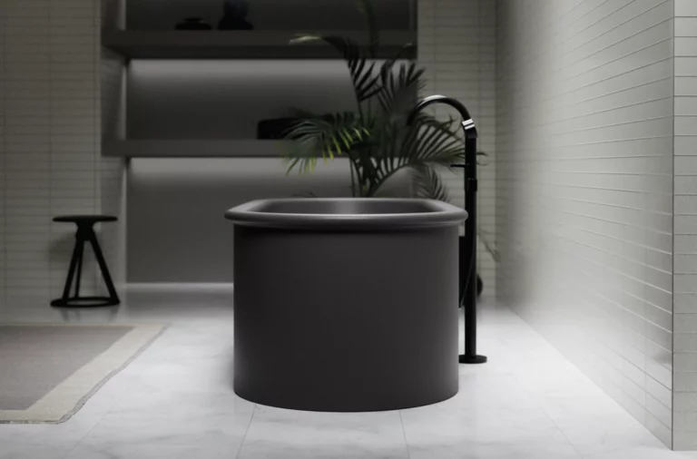 Freestanding round steel-enamel bathtub in dark color, modern bathroom with freestanding faucet.